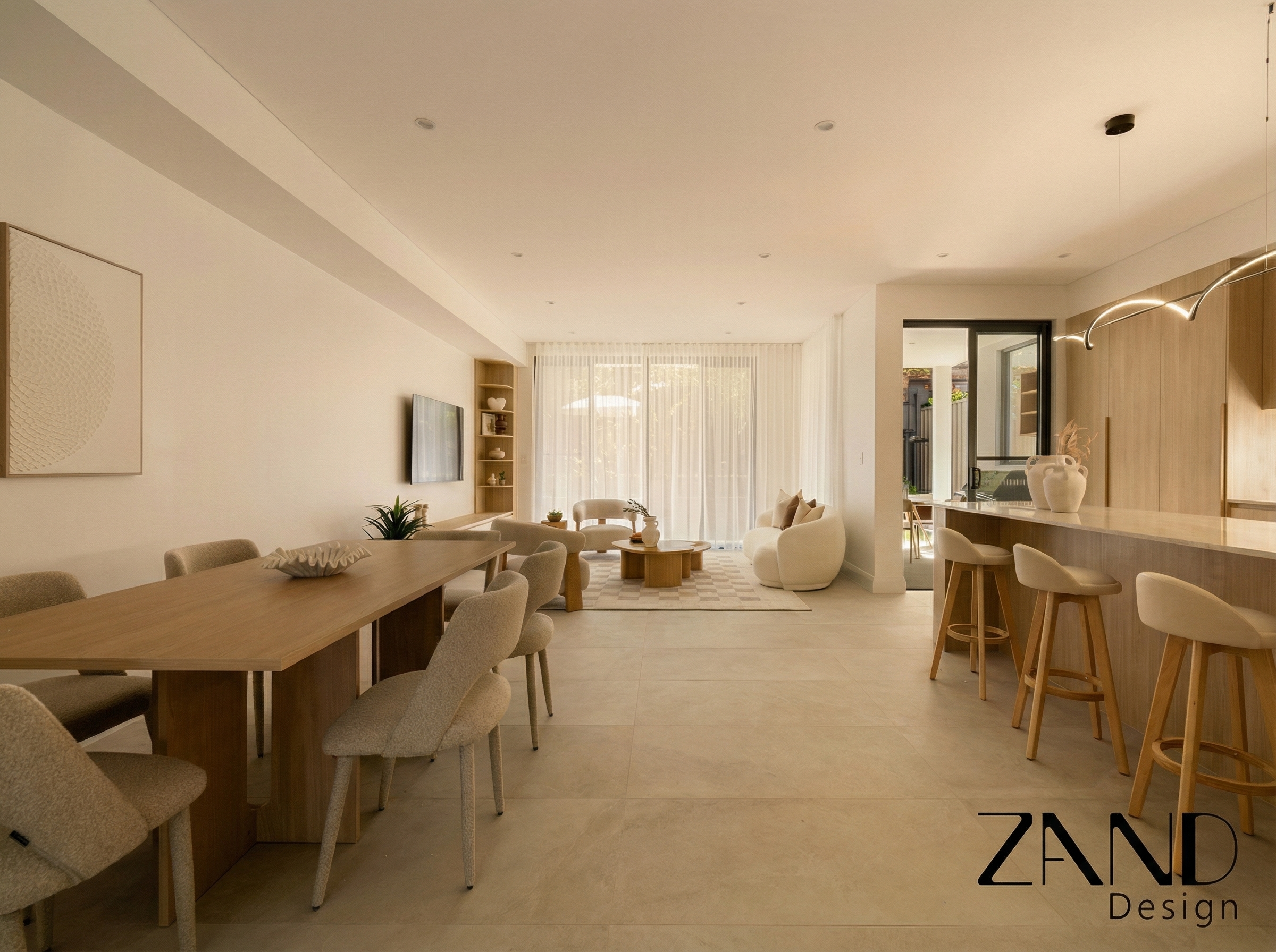 A spacious open-plan dining and living area at 8 Kinross Place, Revesby, designed by Zand Design, featuring a modern timber dining table and minimalist kitchen island.